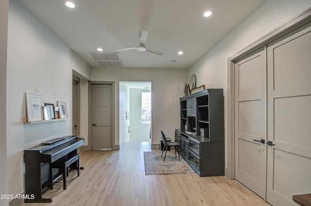 office with ceiling fan and light wood-type flooring