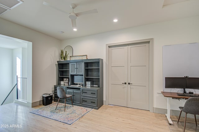 home office featuring light hardwood / wood-style floors and ceiling fan