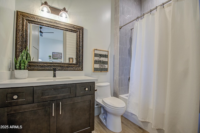 full bathroom with vanity, hardwood / wood-style floors, shower / bath combo, and toilet