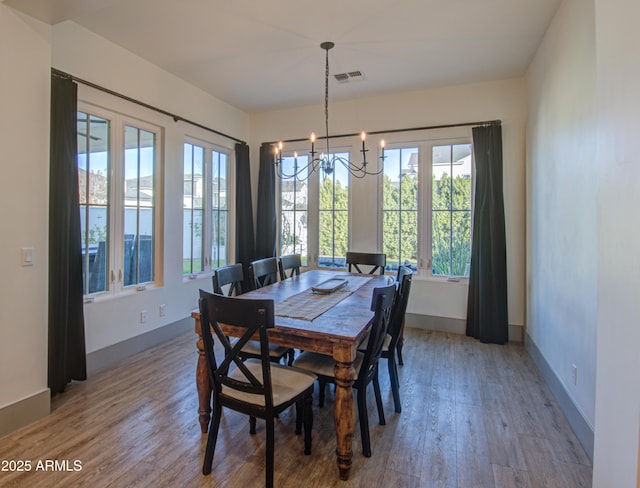 dining area featuring a notable chandelier and hardwood / wood-style flooring