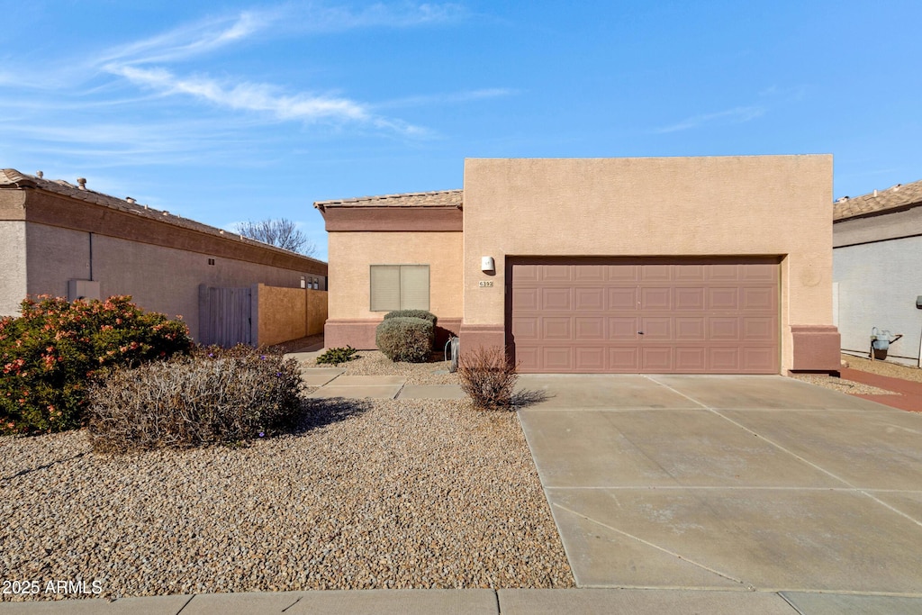 pueblo revival-style home with a garage