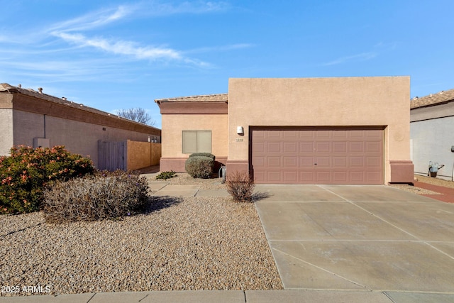 pueblo revival-style home with a garage