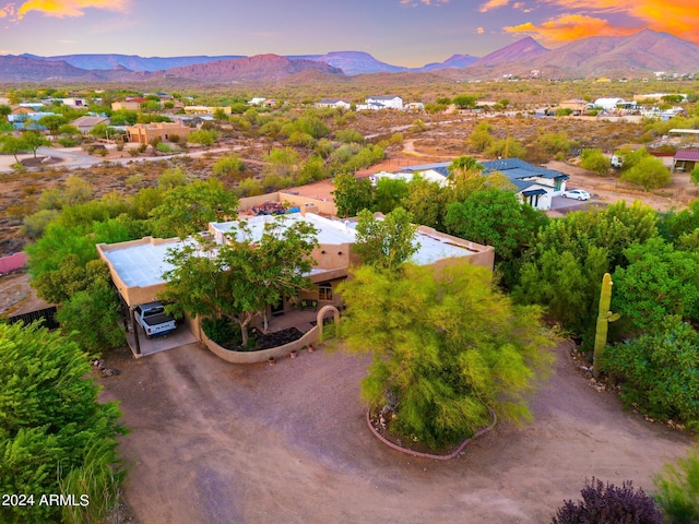 aerial view at dusk featuring a mountain view