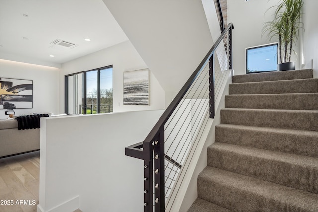 stairs featuring hardwood / wood-style flooring