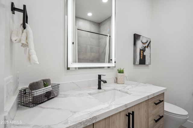 bathroom featuring walk in shower, vanity, and toilet