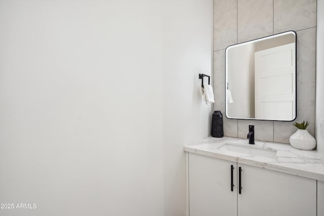 bathroom featuring vanity and backsplash