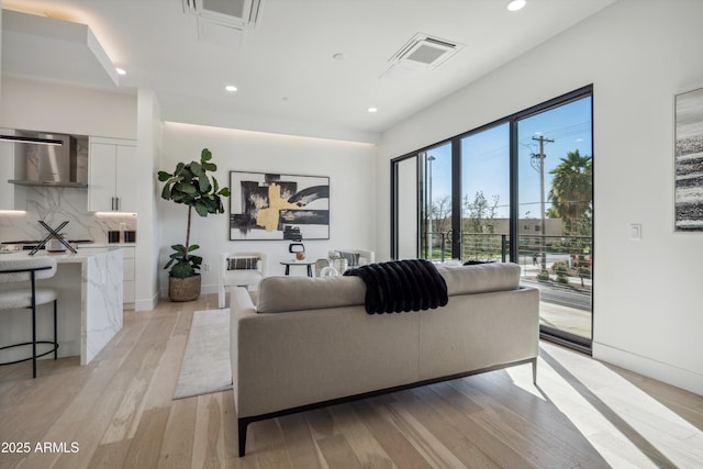 living room with light hardwood / wood-style flooring