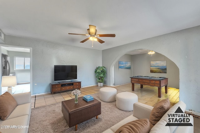 tiled living room with ceiling fan