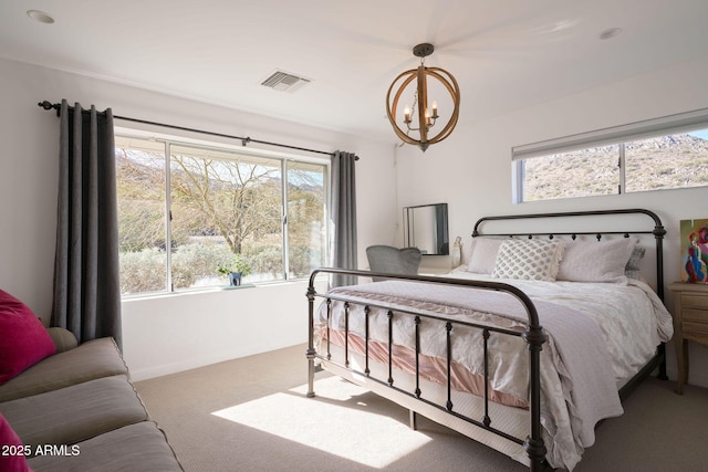 bedroom featuring carpet flooring and a notable chandelier