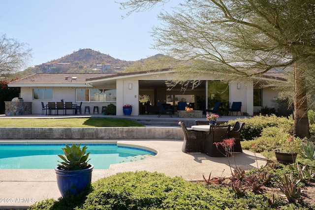 view of swimming pool featuring a patio area and a mountain view