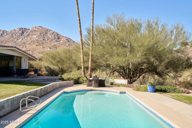 view of pool with a patio area and a mountain view