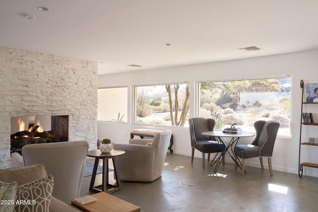 interior space with concrete flooring and a fireplace