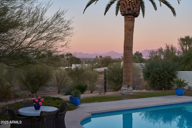 pool at dusk with a mountain view