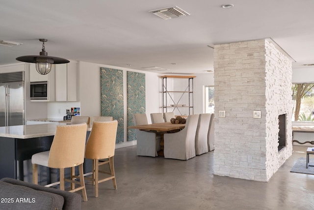 dining space with concrete flooring