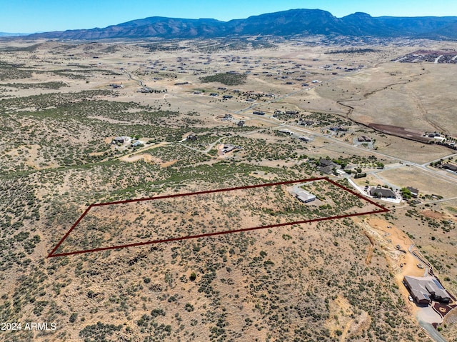 drone / aerial view featuring view of desert and a mountain view