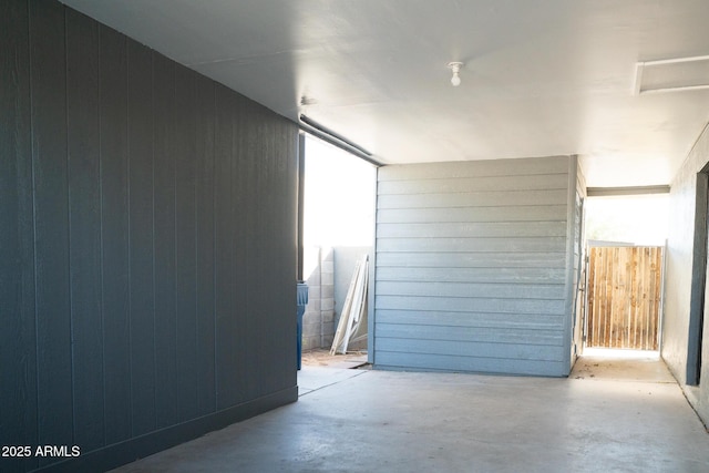 garage featuring wood walls