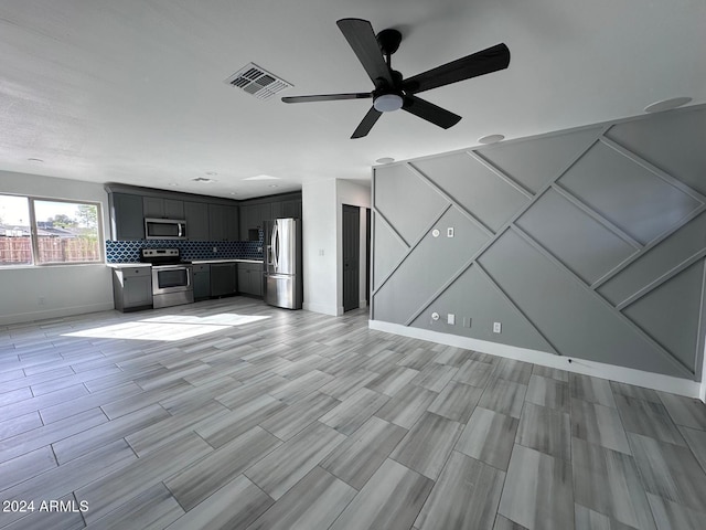 unfurnished living room featuring ceiling fan