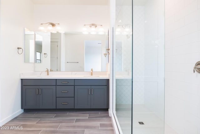 bathroom featuring a tile shower and vanity