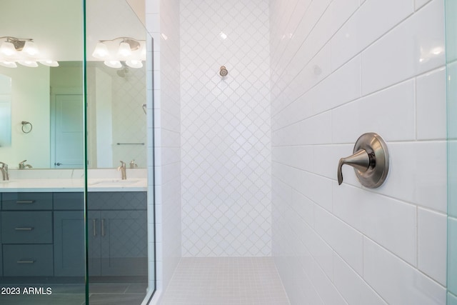 bathroom with vanity and tiled shower