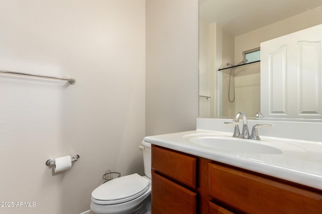 bathroom featuring vanity, toilet, and walk in shower