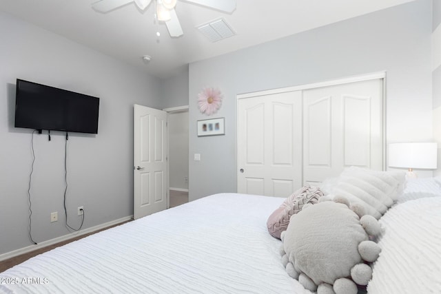 bedroom with ceiling fan and a closet