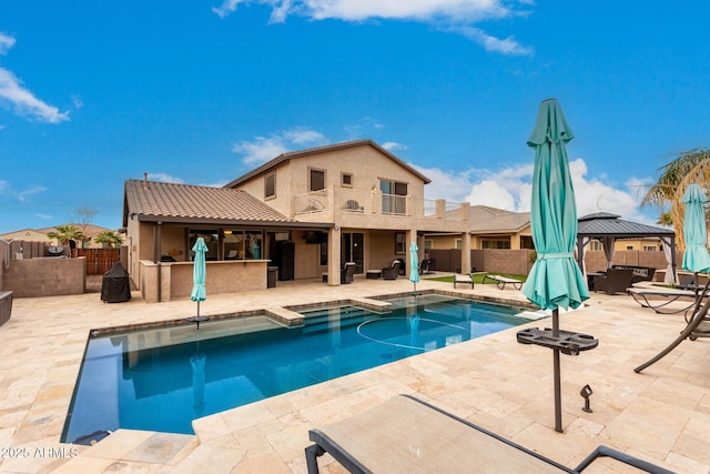 view of swimming pool with a gazebo, a patio, and a bar