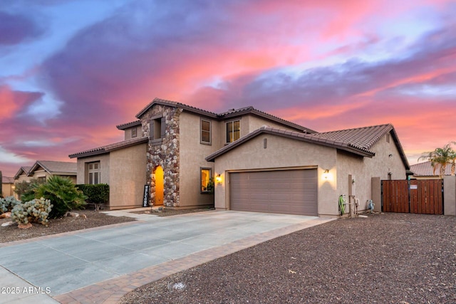 mediterranean / spanish-style home with a garage