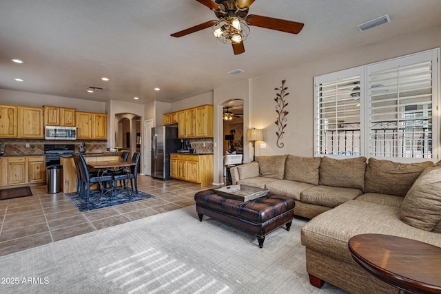 tiled living room featuring ceiling fan