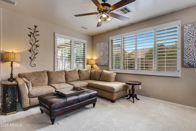 carpeted living room with ceiling fan