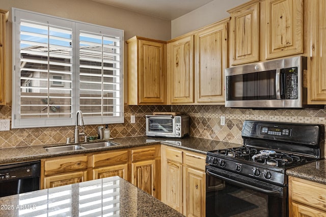 kitchen with tasteful backsplash, sink, black appliances, and dark stone counters