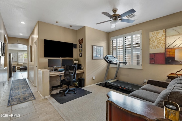 home office with plenty of natural light, light tile patterned floors, and ceiling fan