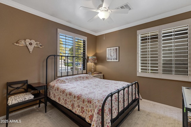 carpeted bedroom featuring crown molding and ceiling fan