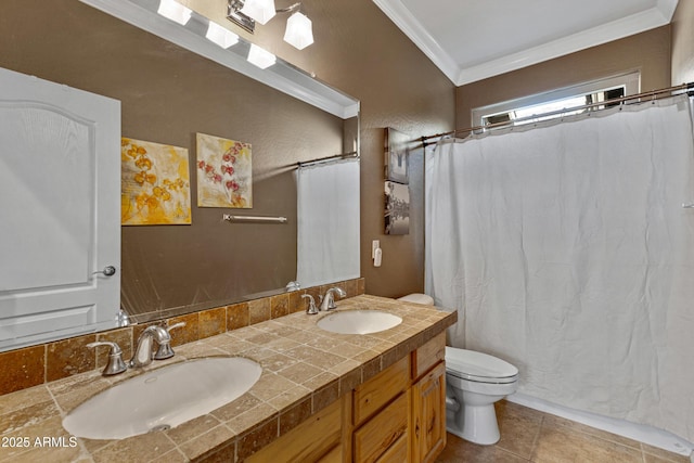 bathroom featuring tile patterned flooring, crown molding, vanity, and toilet