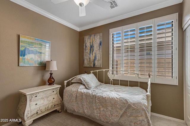 carpeted bedroom featuring crown molding and ceiling fan