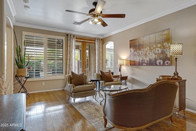 sitting room featuring hardwood / wood-style flooring, ornamental molding, and ceiling fan