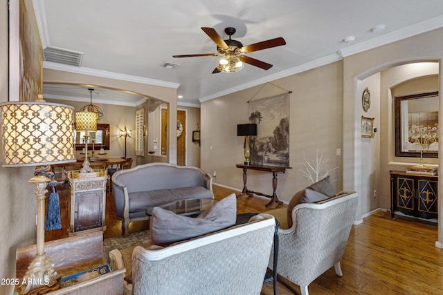 living room with crown molding, ceiling fan, and wood-type flooring