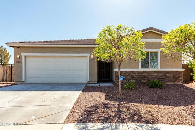 single story home featuring fence, concrete driveway, stucco siding, a garage, and stone siding