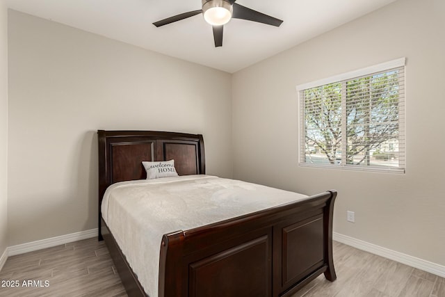 bedroom featuring light wood-type flooring, baseboards, and ceiling fan