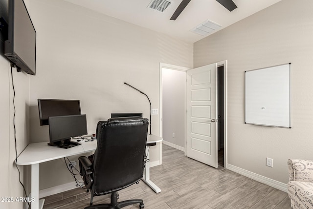 office featuring baseboards, a ceiling fan, visible vents, and wood finish floors