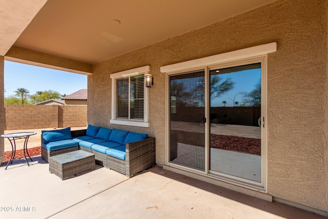 view of patio featuring an outdoor living space and fence