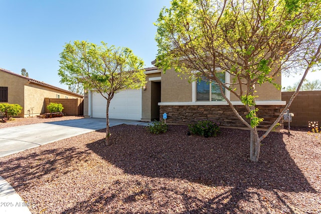 view of front of home featuring fence, driveway, stucco siding, a garage, and stone siding