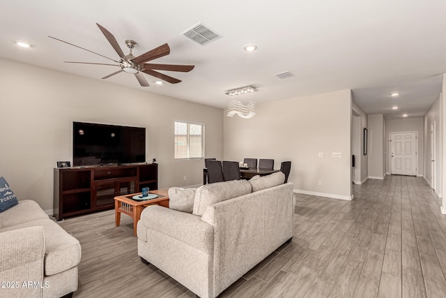 living room with light wood-style flooring, recessed lighting, baseboards, and visible vents