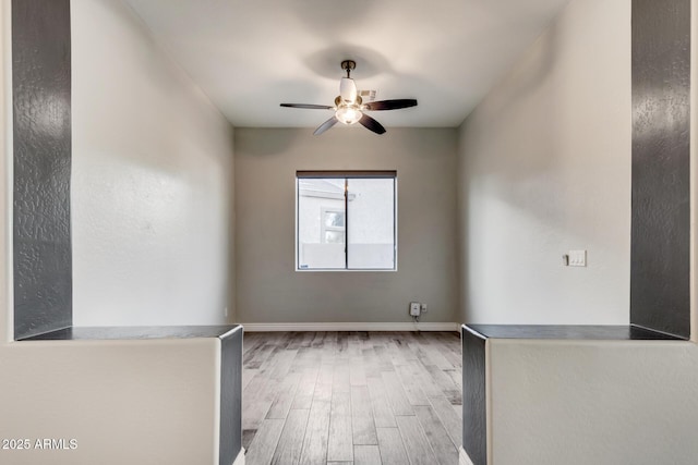 spare room with light hardwood / wood-style floors and ceiling fan