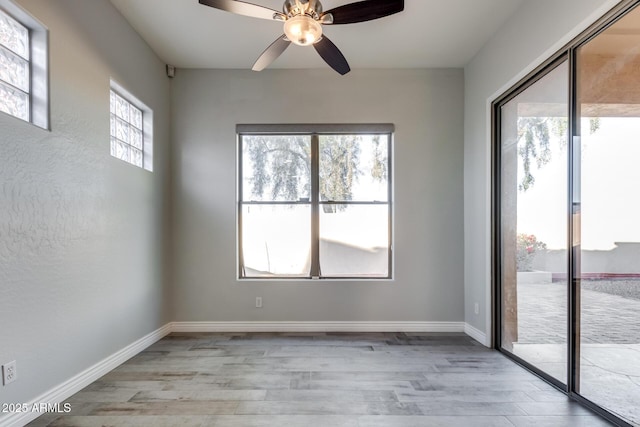 spare room with light wood-type flooring and a wealth of natural light