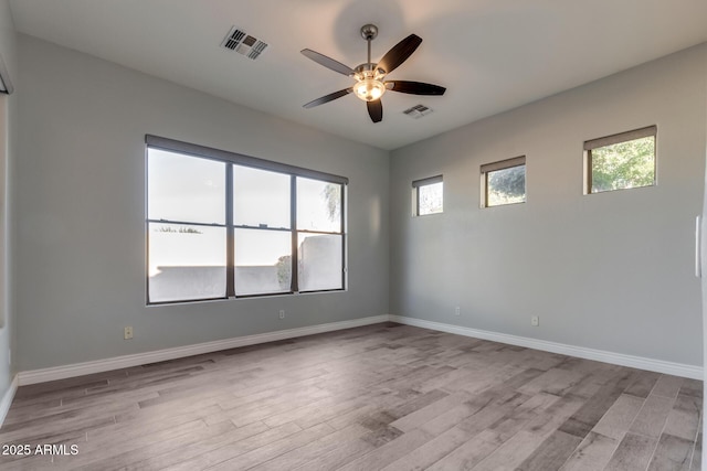 empty room featuring ceiling fan and light hardwood / wood-style flooring