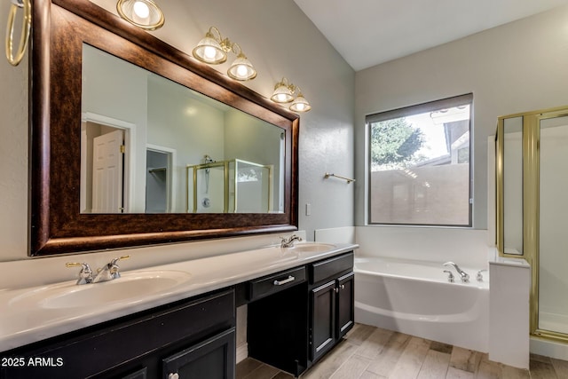 bathroom with hardwood / wood-style flooring, vanity, and plus walk in shower