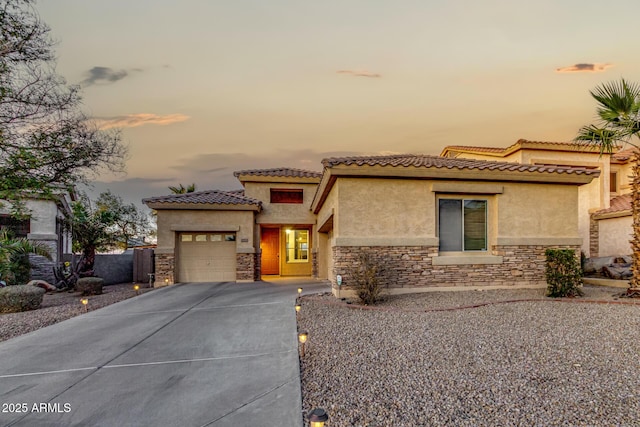 mediterranean / spanish-style home with a garage