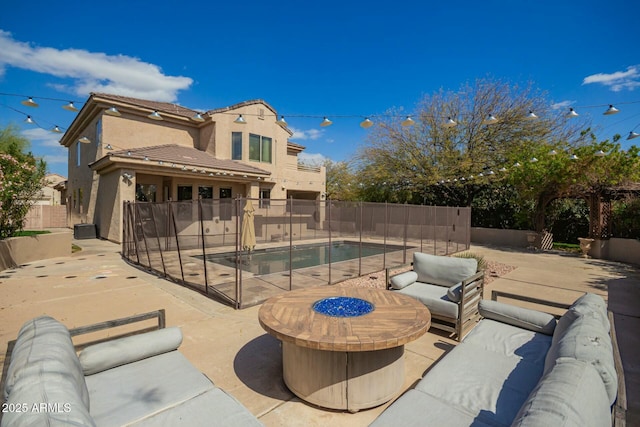 exterior space with outdoor lounge area, a patio area, a fenced backyard, and a fenced in pool