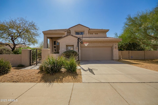 view of front of home with driveway, a tile roof, a gate, fence, and stucco siding