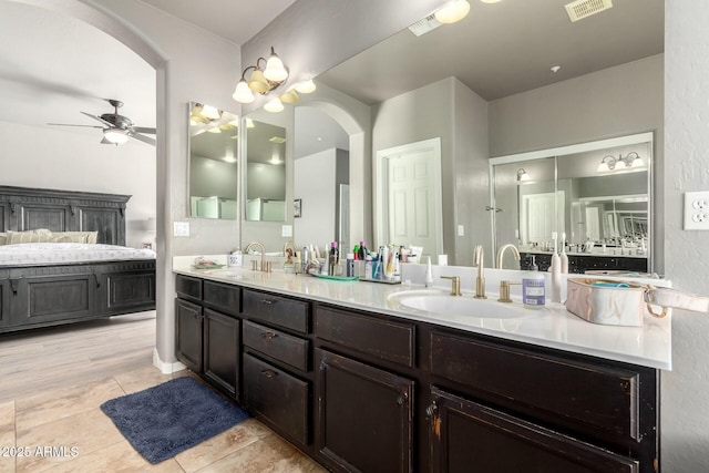 full bathroom featuring double vanity, a ceiling fan, visible vents, and a sink